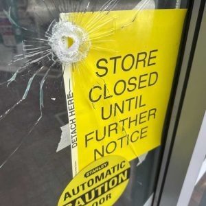 A bullet hole is visible in the door of a CVS pharmacy on Saturday, August 9, 2025, near where police say a man was shooting at the headquarters of the U.S. Centers for Disease Control and Prevention in Atlanta. (AP Photo/Jeff Amy)